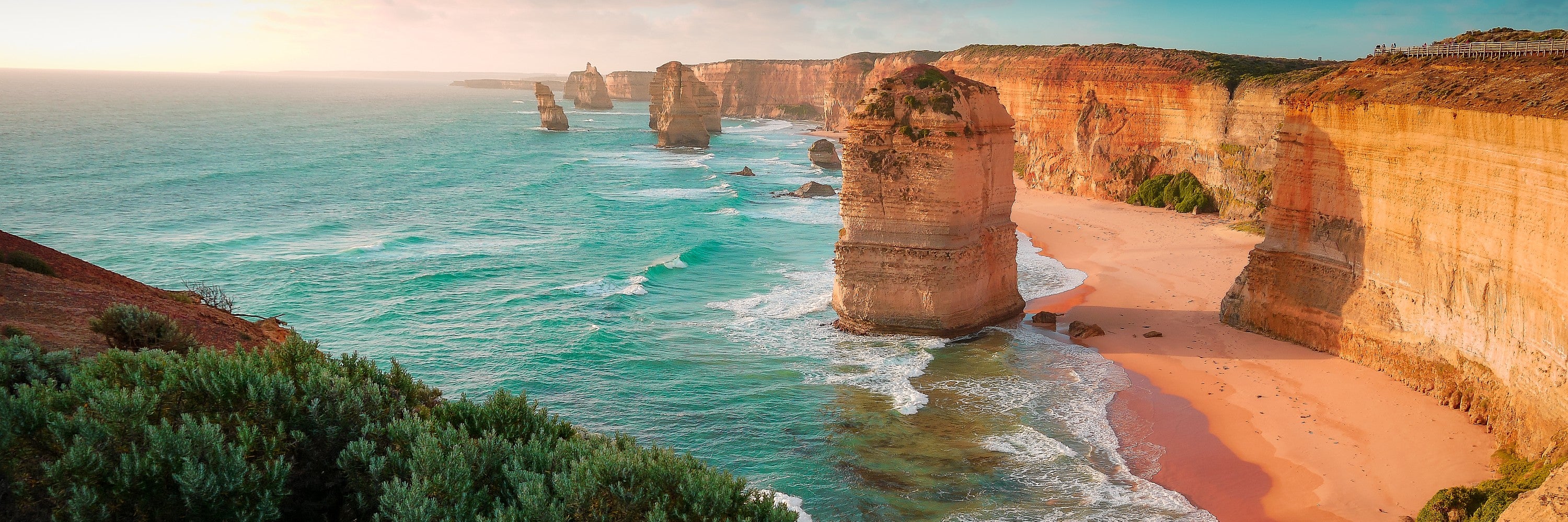 Panoramic sunset view of the Twelve Apostles and limestone coastline along Australia’s Great Ocean Road
